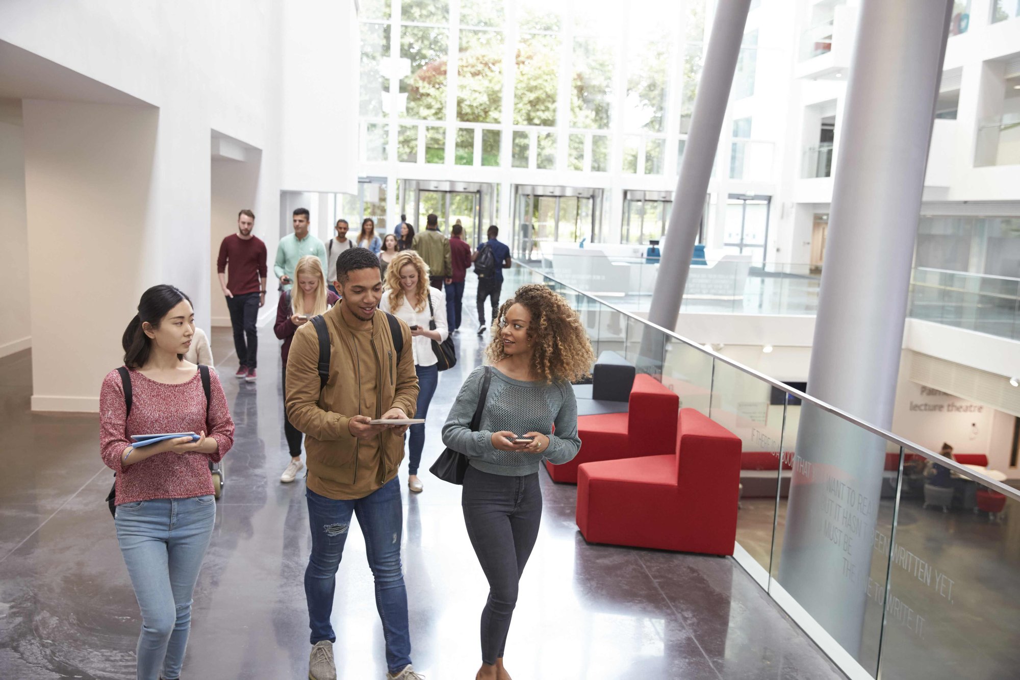 University students inside building walking together