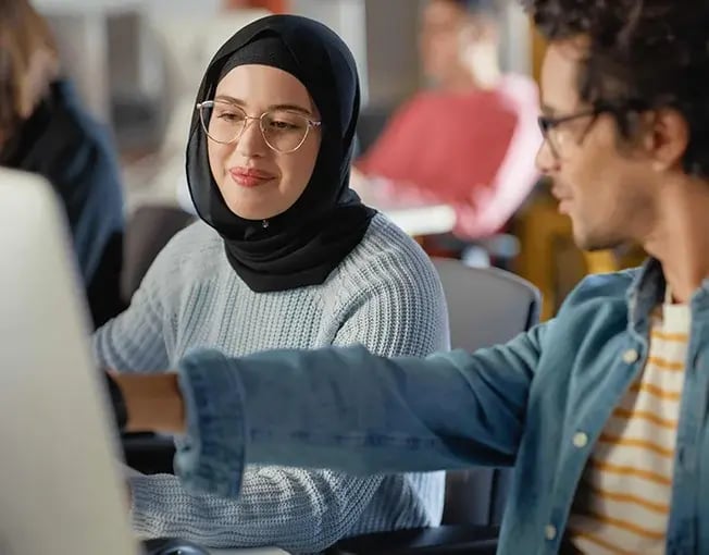 Students advising each other at computer during studies_650